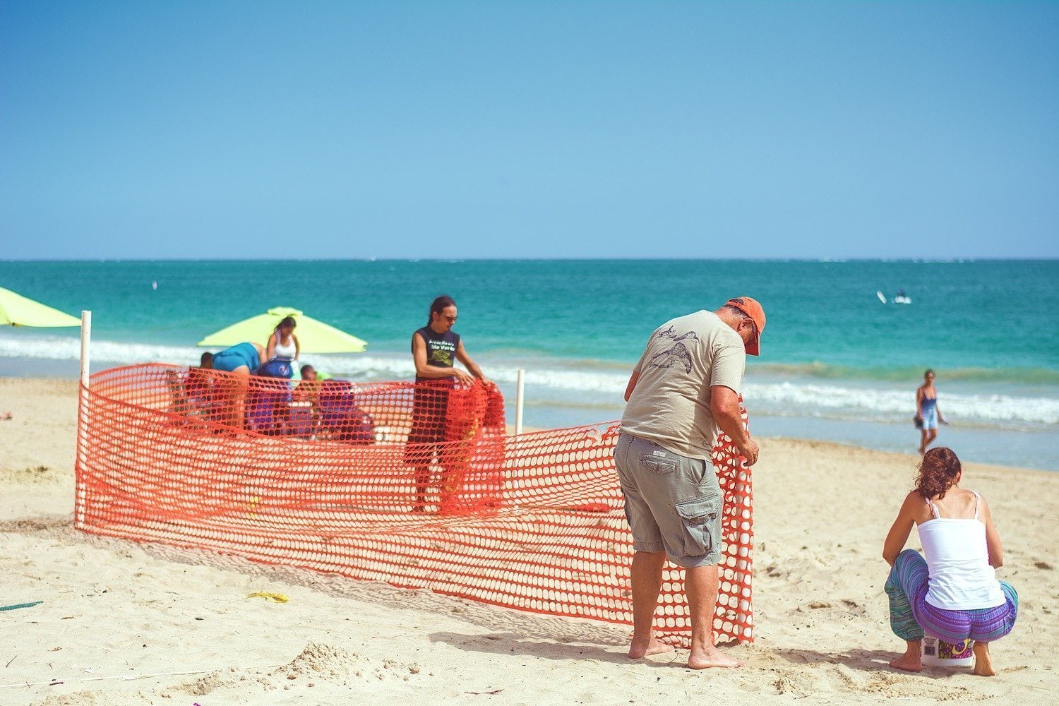 Edwin and Annette setting up a Fence to Protect a Sea Turtle Nest.