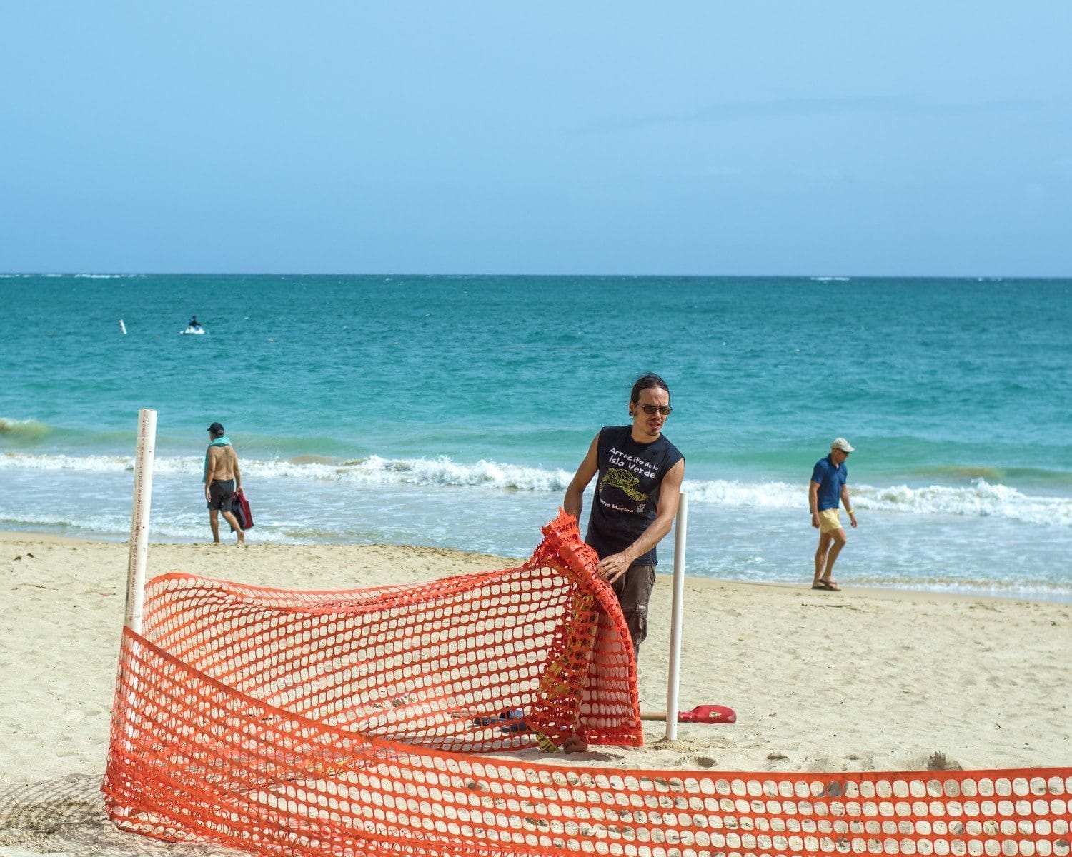 Diego setting up a Fence to Protect a Sea Turtle Nest.
