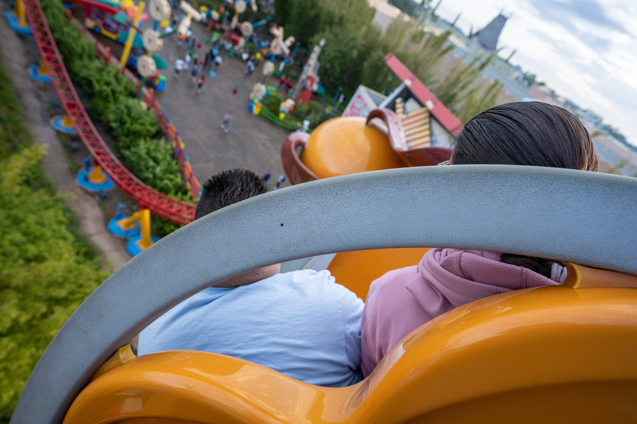 View from Slinky Dog Dash ride at Hollywood Studios, showing vibrant tracks and passengers enjoying the experience.