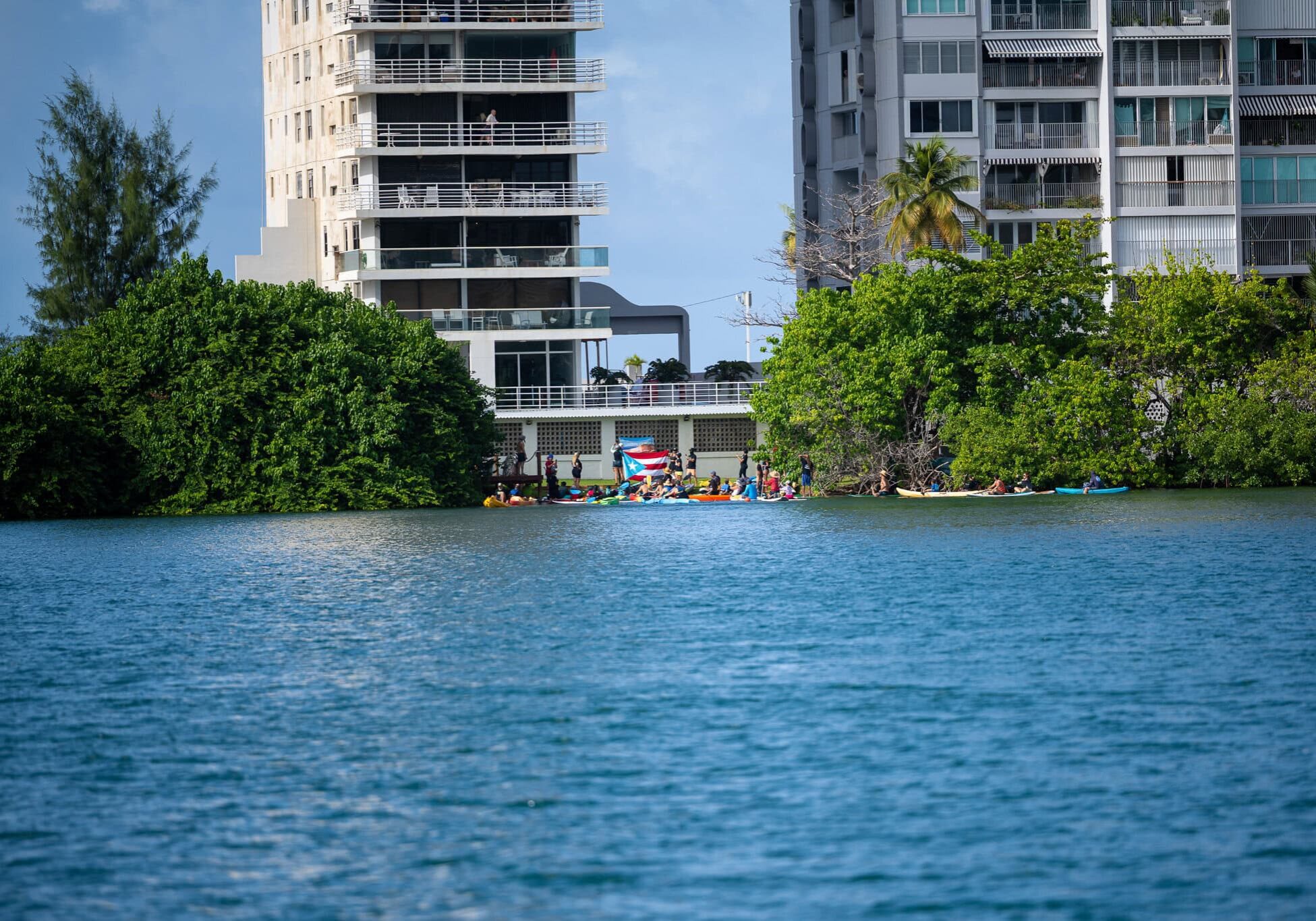 Activists gathered along the shoreline in Condado, Puerto Rico, asserting public access to the beach.