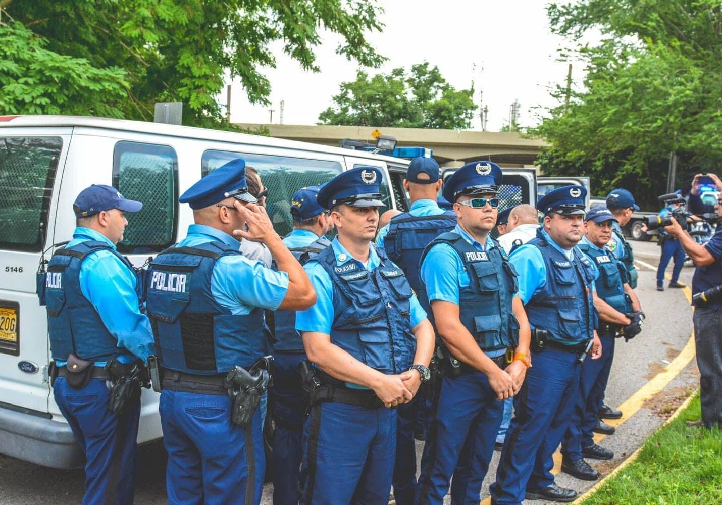 Cops blocking the view of the Arrestees.