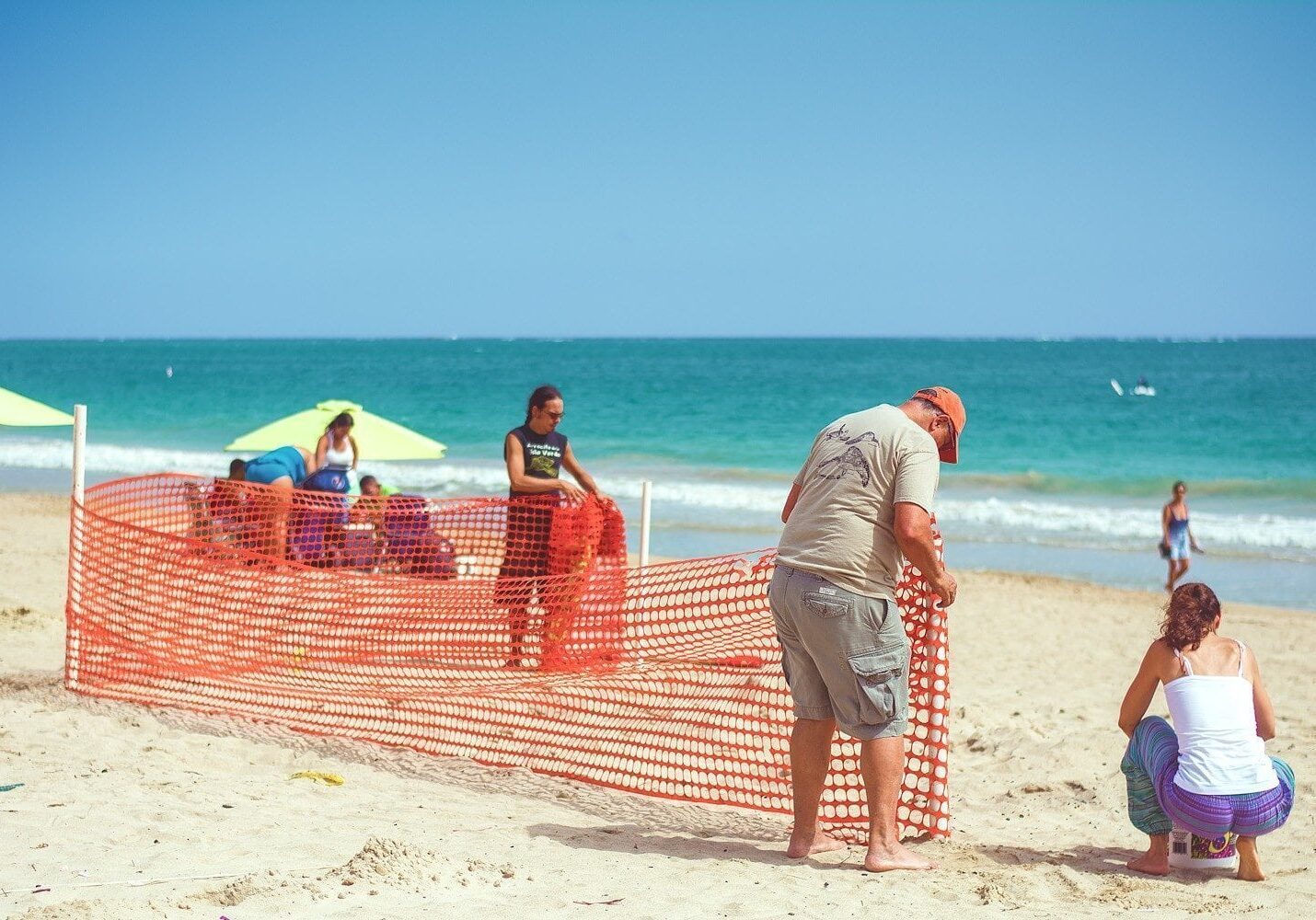 Edwin and Annette setting up a Fence to Protect a Sea Turtle Nest.