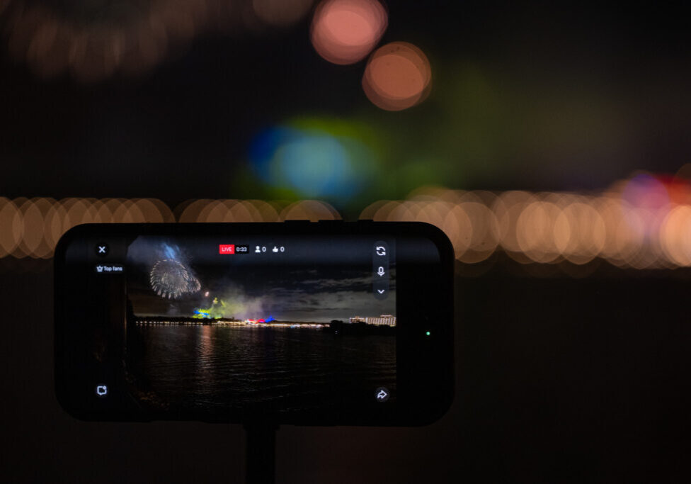 A iphone recording Magic Kingdom fireworks across the water from Disney’s Grand Floridian during a Christmas party.