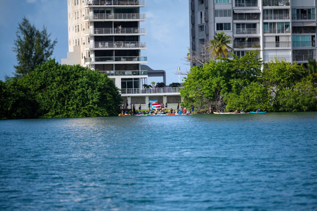Activists gathered along the shoreline in Condado, Puerto Rico, asserting public access to the beach.