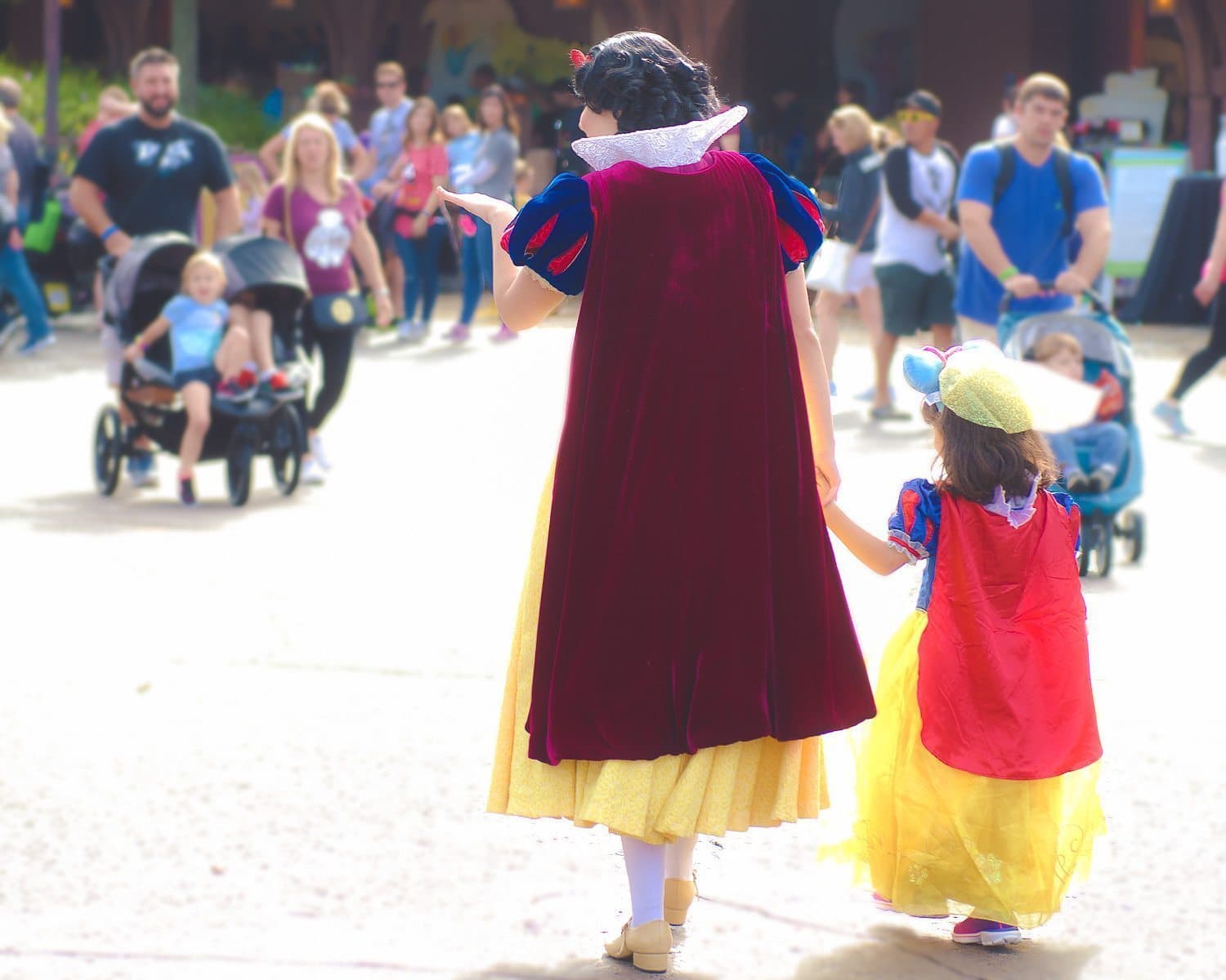 Daniela and Snow White walking down FantasyLand.